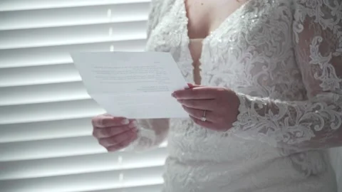 Bride Reading Letter on Wedding Day Video stock 148695572