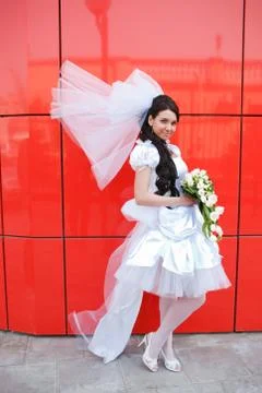 Bride by the red wall Stock Photos
