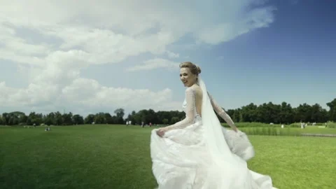Bride is running on the green field Stock Footage 172736102