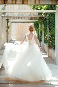 The bride runs in the park Stock Photos