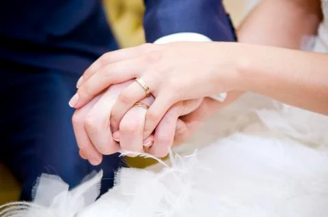 The bride s hand with a wedding ring lies on the groom s hand with a wedding Stock Photos