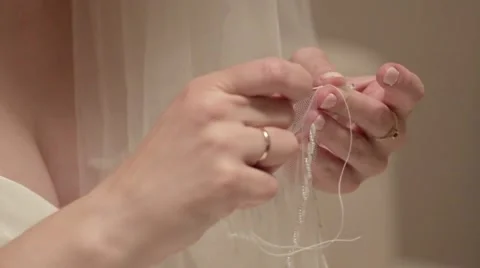Bride sews veil Stock Footage 57211369