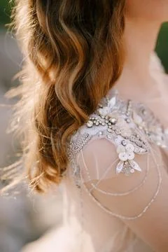 Bride shoulder in a sequin and beaded tulle dress. Close-up Stock Photos