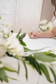 Bride signing the wedding documents at the registry office Stock Photos