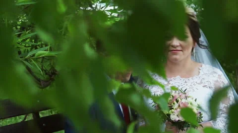 The bride sits on the groom's lap Stock Footage 107676312