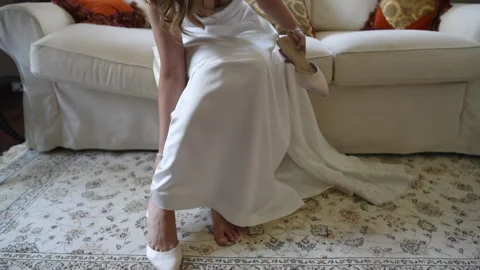 Bride sits on white sofa Stock Footage 278406500
