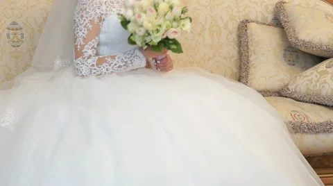 Bride sitting on sofa during photo session indoors Stock-Footage 68625299