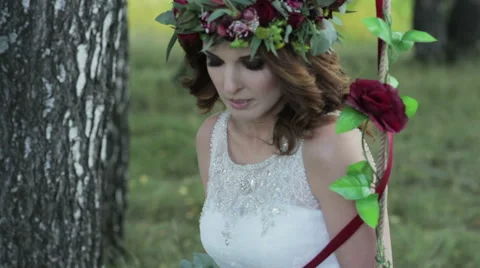 Bride sitting on a swing close-up Stock Footage 60009654