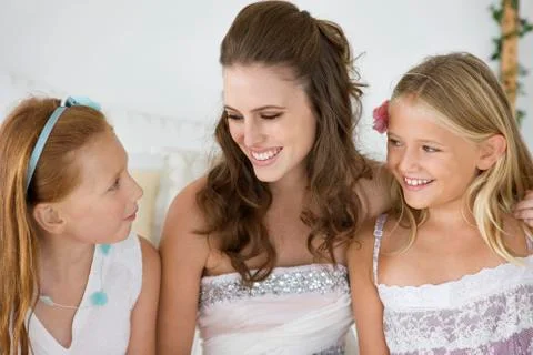Bride sitting with two girls Stock Photos