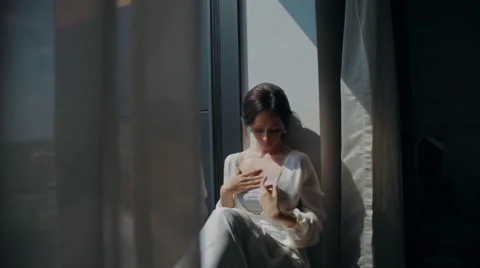 Bride sitting on a window Stock Footage 67531974