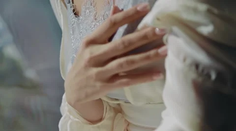 Bride sitting on a window, hands and face. Close-Up Stock Footage 67531950