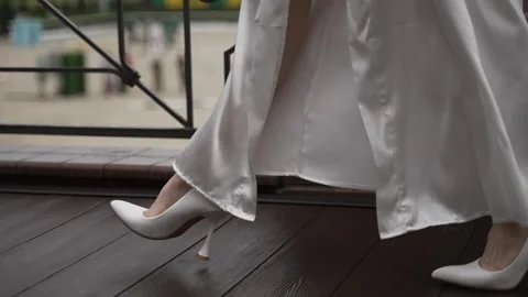 Bride with slender legs in white high-heeled shoes Stock Footage 302309752