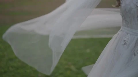 Bride in slow motion with veil blowing in the wind outdoors. Stock Footage 322900228