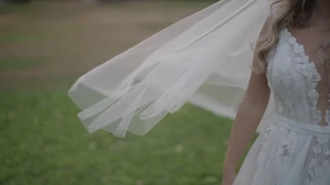 Bride in slow motion with veil blowing in the wind outdoors. Stock Footage 322900229