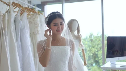 The bride smiled happily and prepared herself in the dressing room. Stock Footage 99208990