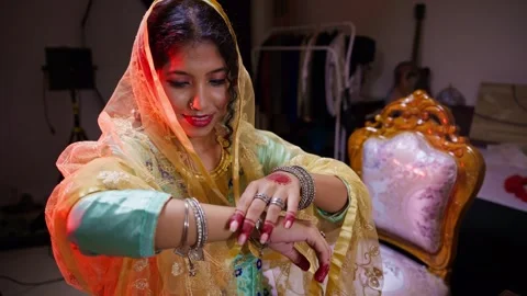 Bride smiles happily while looking at ornaments Stock Footage 302071775