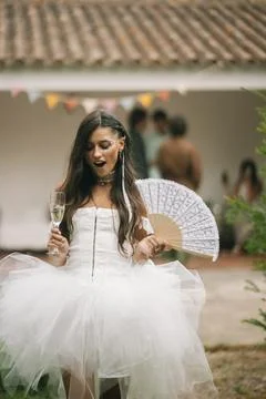 Bride Smiling With Glass And Patterned Fan Stock Photos