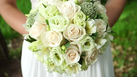 The bride is standing with a bouquet Stock Footage 163566625