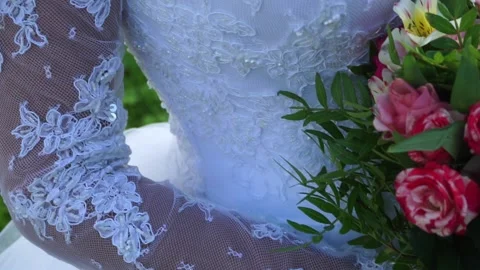 The bride is standing with a bouquet Stock Footage 163566773