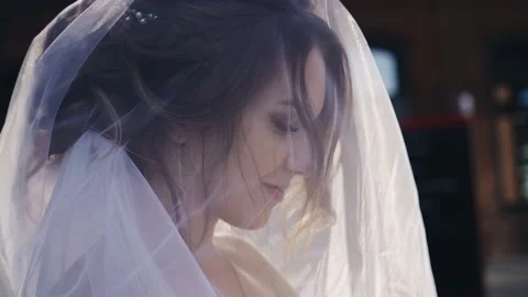 The bride is standing in the city on and her face is covered with a veil Stock Footage 166059870