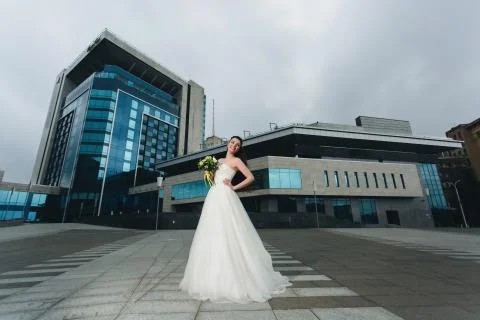 Bride standing in front of the high building Stock Photos