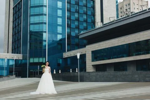 Bride standing in front of the high building Stock Photos