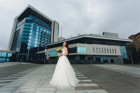 Bride standing in front of the high building Stock Photos