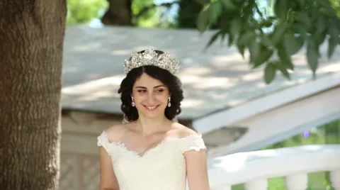 The bride standing at the tree and smiling Stock Footage 68905259