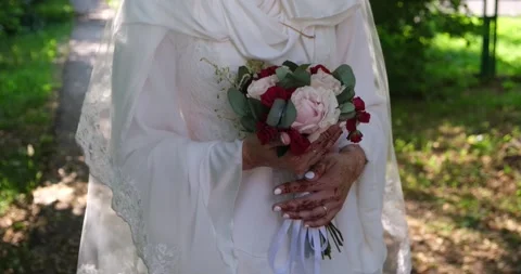 A bride stands with a bouquet close-up Stock Footage 221267747