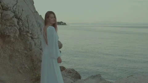 A bride stands on a rocky seashore Stock-Footage 232754516