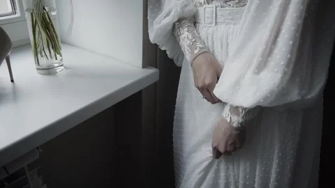 The bride stands at the window in a dress Stock Footage 306148011