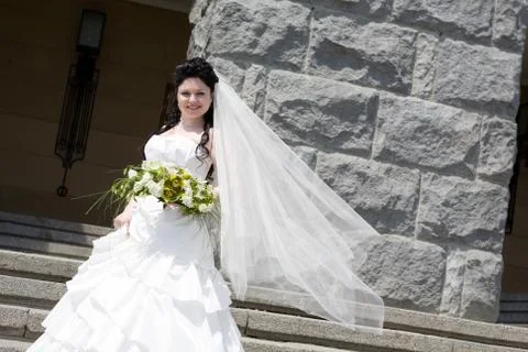 Bride by the stone wall Stock Photos