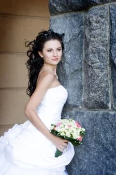 Bride by the stone wall Stock Photos