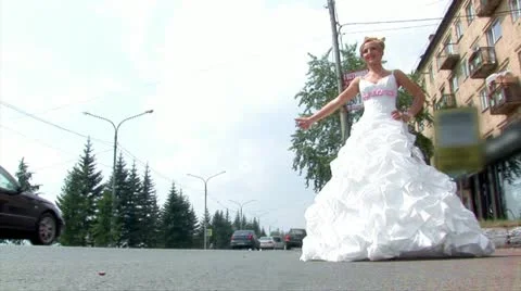 Bride is stopping a car (medium shot) Stock Footage 11291260