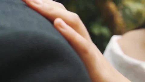 The bride strokes the groom on the shoulder. Close-up of a hand. Video stock 140397643