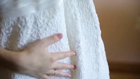 Bride stroking her dress hand Stock Footage 70383440