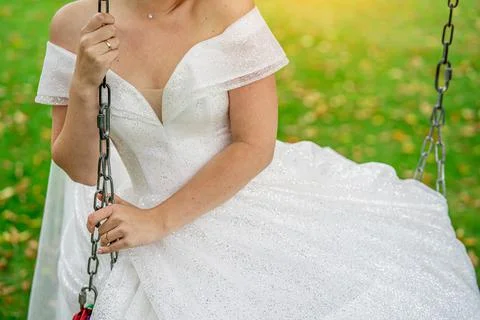 Bride on a swing close-up without a face. Stock Photos
