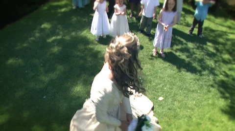 Bride throws her bouquet at happy summer outdoor wedding. 스톡 동영상 32941380