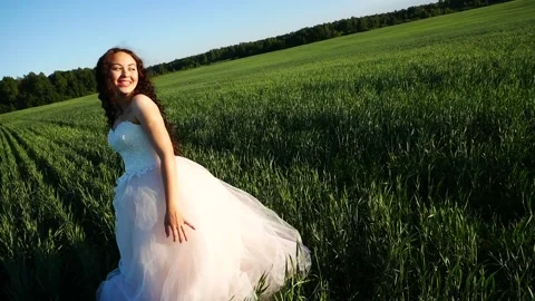 Bride throws her wreath aside and laughs and rejoices. Stock Footage 205447655