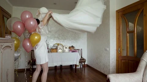 The bride tosses and dancing with her dress in slow motion shot Stock Footage 233524325