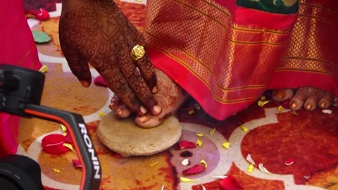 Bride Touch Stone by toe and groom touch stone by finger in seven steps ceremony Stock Footage 246402217
