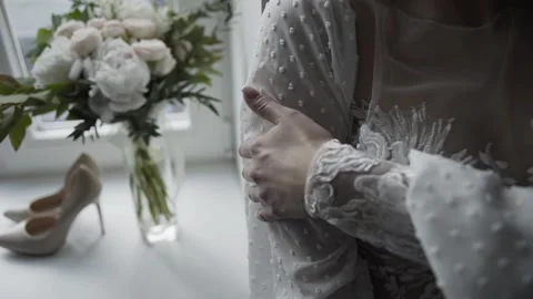 Bride touches herself standing in front of the window 库存影片 306148019