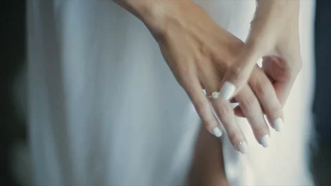 Bride touches a wedding ring on her finger Stockbeeldmateriaal 102931964