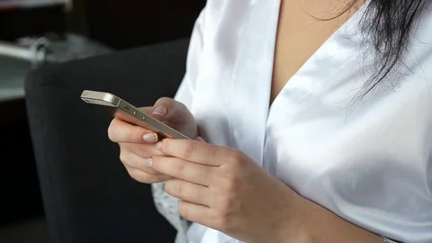 Bride typing sms by the mobile phone Stock Footage 70914247