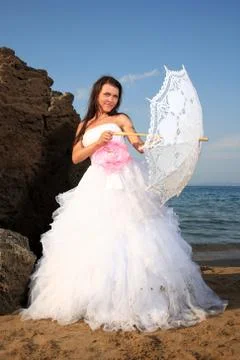 Bride with umbrella Stock Photos