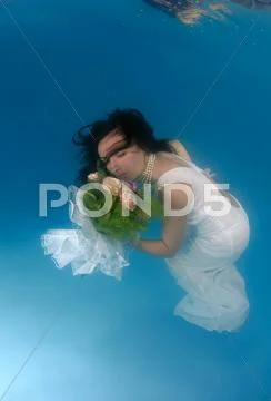 Bride, underwater wedding in a pool Stock Photos