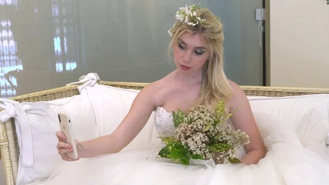 Bride using a smartphone Stock Footage 129865185