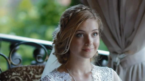 Bride wait sher groom on the summer terrace of cafe Stock Footage 64205035