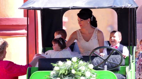 Bride waiting sit in a old car ready to enter to the church. Stock Footage 60696342