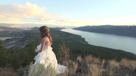 Bride Walk Down Clifftop Overlook with Valley Below Stock Footage 67904647